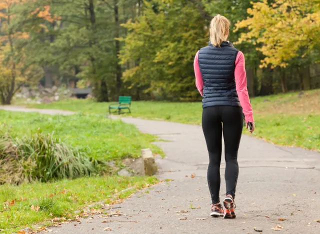 a healthy woman walking on the road